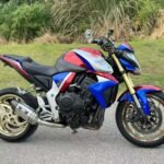 La Honda CB1000R Bumblebee Mutant est bien plus qu’une moto : c’est une préparation unique, pensée pour offrir un style radical et une expérience de conduite intense. Inspirée de l’univers racing et custom, elle se distingue par son habillage personnalisé type Bumblebee, immédiatement reconnaissable. Équipée d’un monobras oscillant, elle allie esthétique premium et stabilité optimale. L’échappement Yoshimura apporte une sonorité sportive emblématique, tout en améliorant les performances et le caractère du moteur. Cette CB1000R est idéale pour les motards à la recherche d’une moto exclusive, performante et différente des modèles d’origine. Une véritable pièce de caractère, prête à attirer tous les regards.